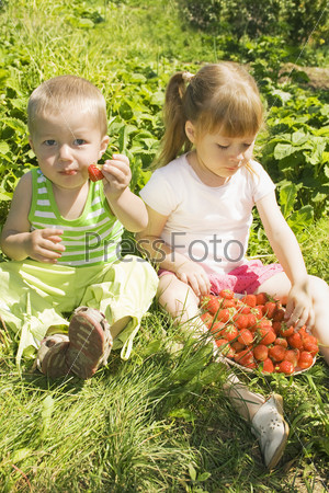 Child eating strawberries.
