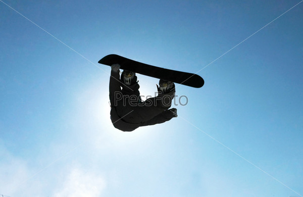 A snowboarder going big high above the half pipe