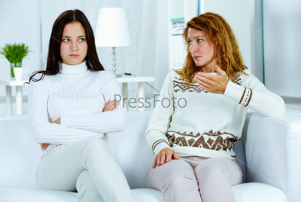 Photo of pretty woman looking at her stubborn daughter during argument