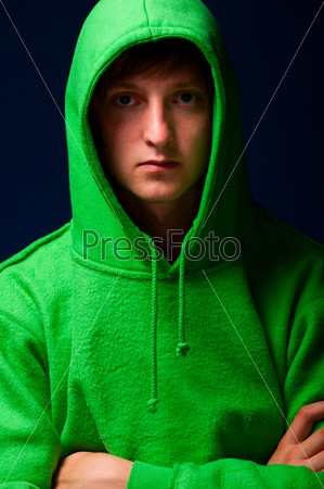 young man in green sweatshirt with turned up hood