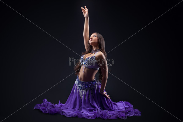 arabia dancer posing in dark - oriental costume
