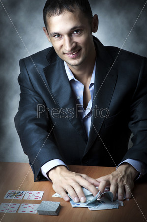 Portrait of young adult handsome man playing poker who win a lot of money. A stroke of luck - All in