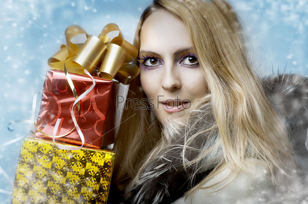 Christmas concept. Beauty portrait happy woman model holding two gift boxes in hands and smile