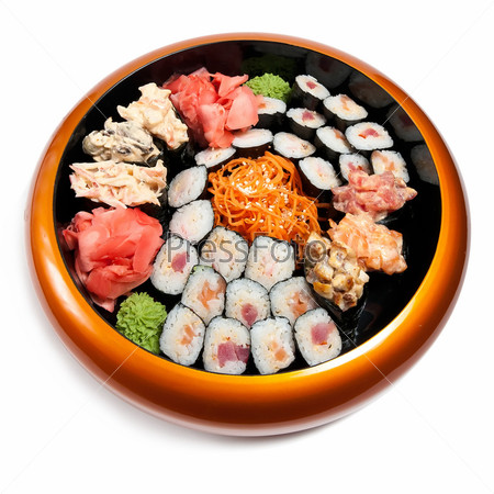 Set of sushi in wooden circle plate isolated on white