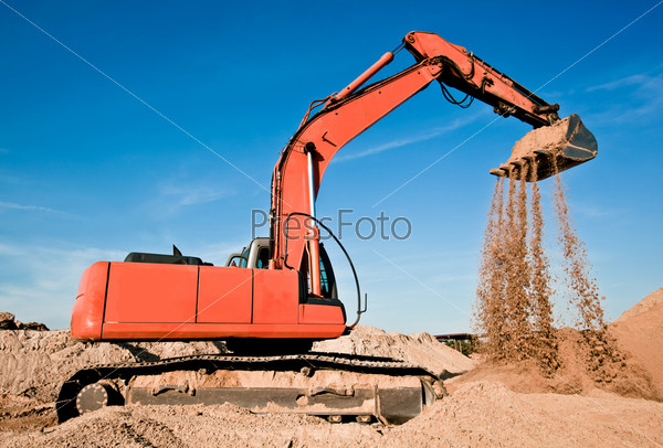 Track-type excavator in sand quarry