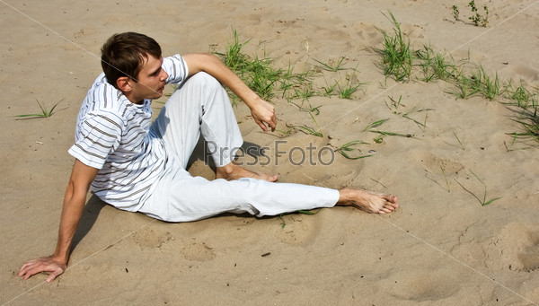 Low spirits man sitting on the sand