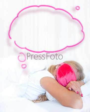 Bedroom surprise present - young happy woman in bedroom. With blank balloon with lots of copy-space for your text and logo overhead