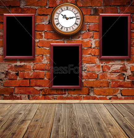 empty photo frames and watch against an brick wall in old room
