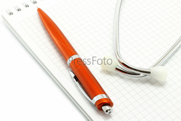 Ball pen and phonendoscope on the notepad