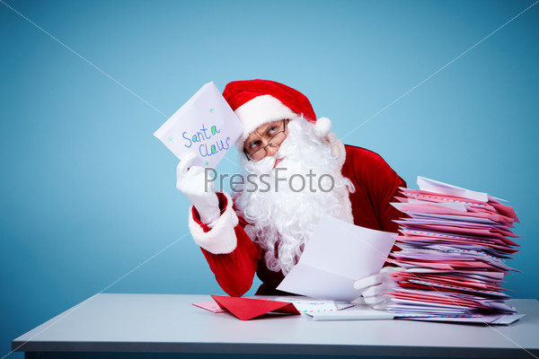 Portrait of Santa Claus thinking about ideas while reading letters