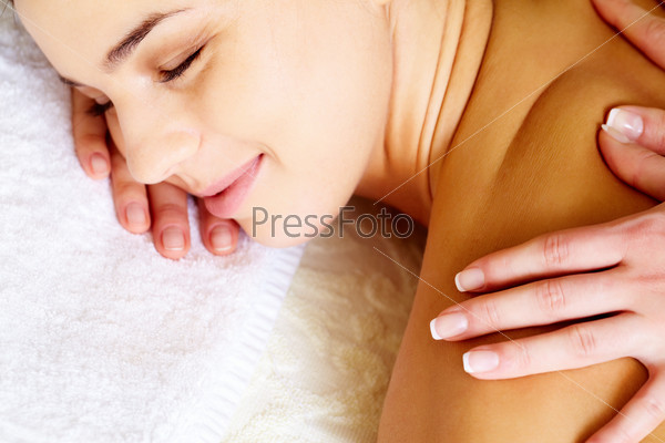 Close-up of pleased female during luxurious procedure of massage