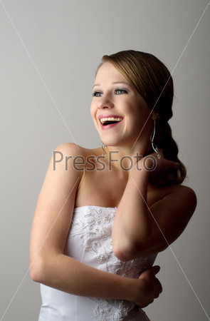 Beautiful young woman in evening dress laughs