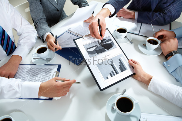 Image of human hands during discussion of business plan