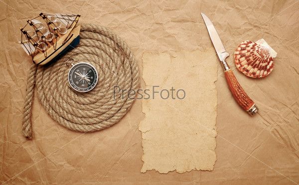 rope coil, decorative knife and model classic boat on old paper