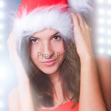 20-25 years od beautiful woman in Christmas dress dancing at club while celebrating Christmas party