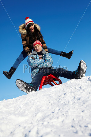 Portrait of happy couple in warm clothes having fun outdoor in winter