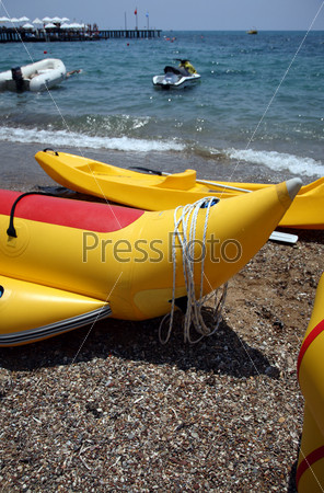 yellow inflatable boats for entertainment, ashore sea