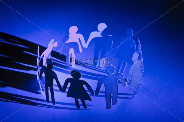 Group of paper doll people holding hands, stock photo