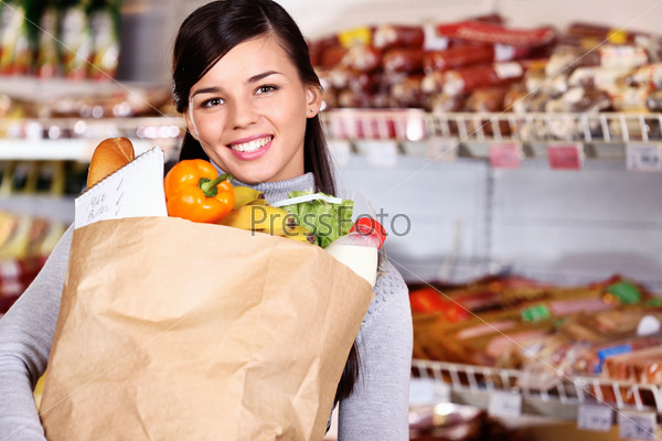 Image of pretty woman with pack of products looking at camera