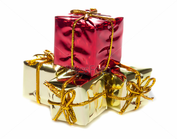 Closeup of four small red and yellow  gift boxes with gold tapes on white