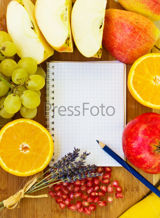blank white notebook  paper for recipes with colorful fruits - apples, oranges, grapes
