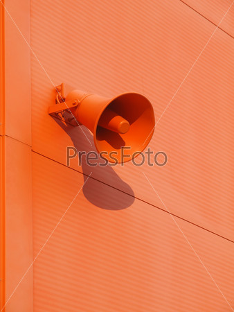 Loudspeaker on the wall of orange color