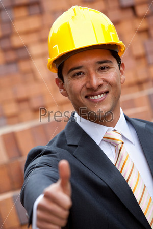 Engineer with thumbs-up at a construction site