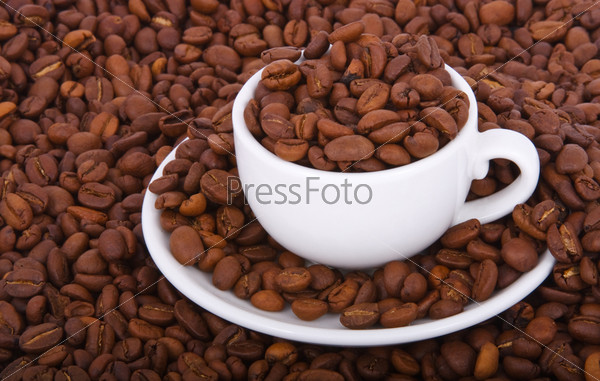 Small Cup with coffee, costing on coffee grain