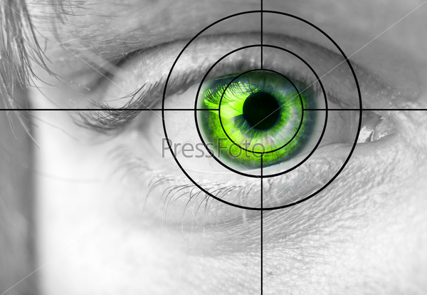 Man\'s green eye and target close up