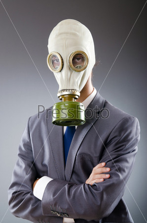 Businessman wearing gas mask, stock photo