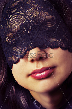 Sexy female full lips with red lipstick closeup and lace mask over eyes