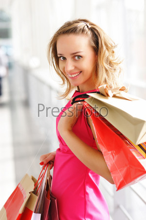 Woman with bags in shopping mall