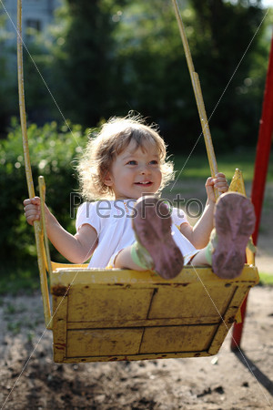 Playing on the swings after summer rain - shallow depth of field, back lighting