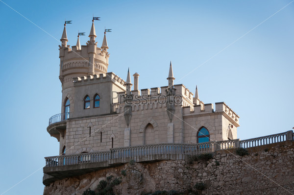 Fantastic castle on a rock: Swallow\'s Nest Castle tower, Crimea, Ukraine, with blue sky and sea on background