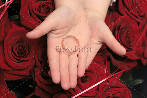 Two rings in children hands on ren rosa background, stock photo