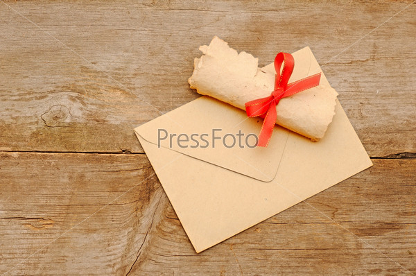 envelope old paper roll over wood background