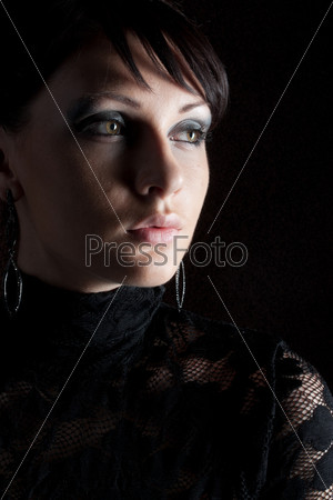 Portrait of a romantic girl under the dark background