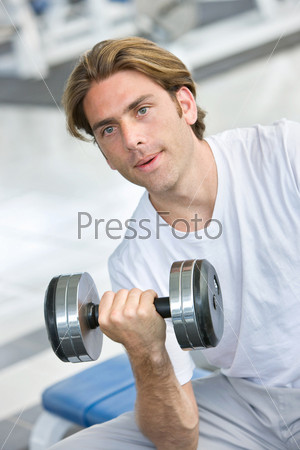 man lifting free weights at the gym