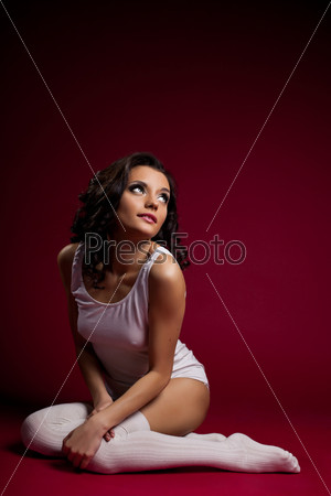 Woman in white sit in dark red place fear from light