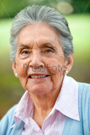 Portrait of a lovely old woman smiling outdoors