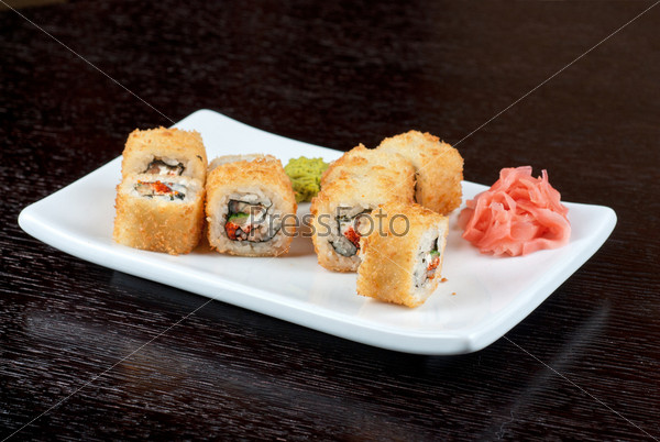 Sushi rolls made of rice, smoked eel, cream cheese and flying fish roe - tobiko caviar