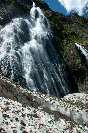 Waterfalls and glaciers and green valleys. Exotic picture - ice, water, forest, summer in one palette, stock photo