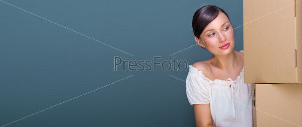 Closeup portrait of a young woman with boxes. Lots of copyspace