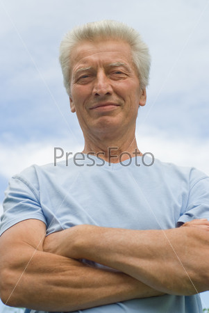 beautiful older man stands on the sky
