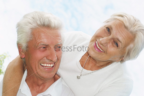 happy old couple in a summer park