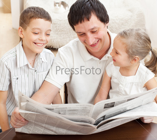 Family reading a newspaper