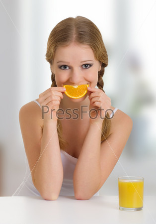 beautiful young woman full of life with orange juice