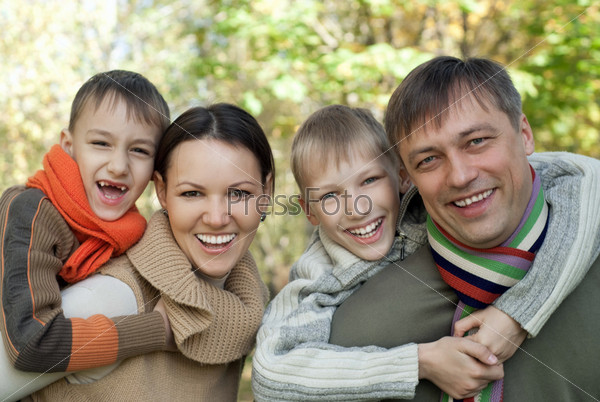 Portrait of a nice family of four on the nature, stock photo