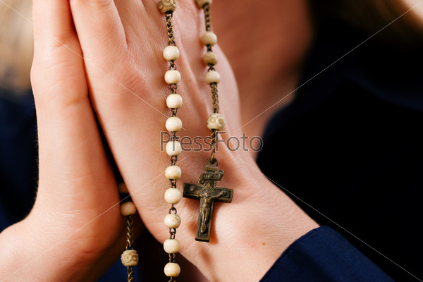 Woman (only hands to be seen) with rosary sending a prayer to God