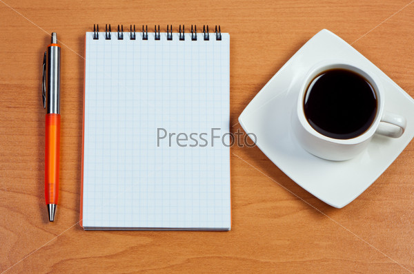 Pen, notebook and cup coffee on table, stock photo